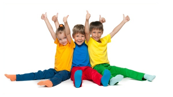 Three happy children hold their thumbs up on the white background